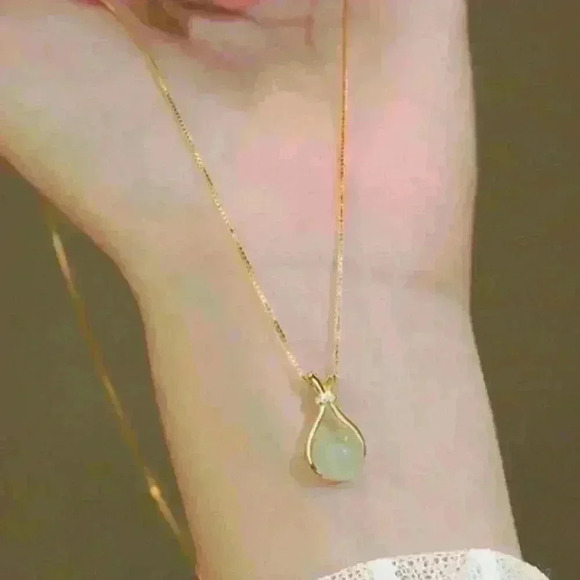 Jade Stone encased in a sleek gold necklace, accented with a sparkling c… - Picture 3 of 4